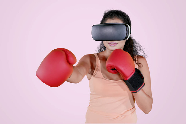 Woman exercises with VR glasses and boxing gloves - Φωτογραφία, εικόνα