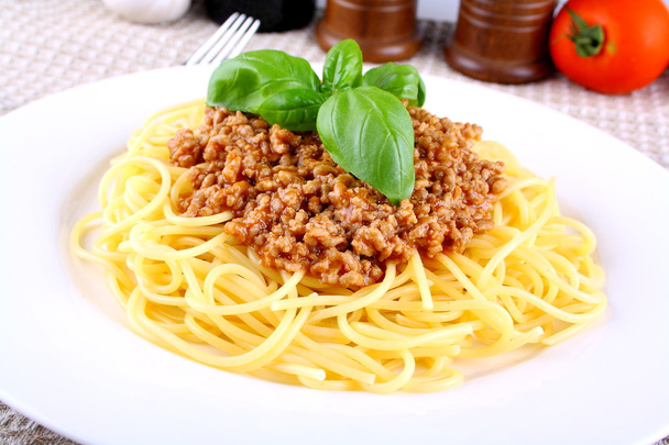 Spaghetti bolognese with basil on white plate - Photo, Image
