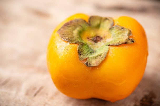 Close up of persimmon fruit on wooden - Foto, imagen