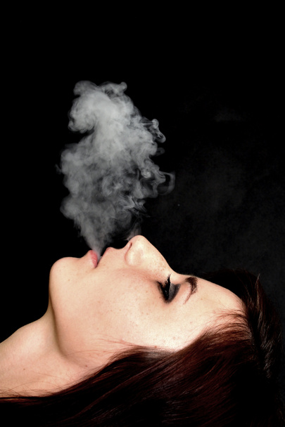Woman smoking e-cigarette - Фото, изображение