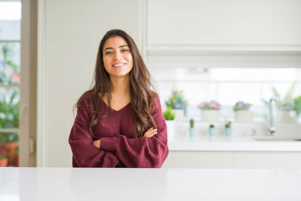Young beautiful woman at home happy face smiling with crossed arms looking at the camera. Positive person. - Photo, image