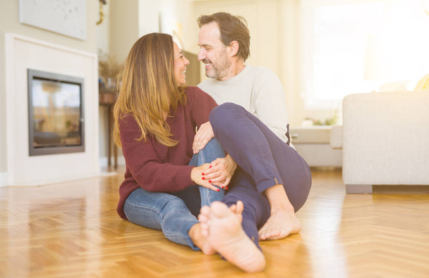 Beautiful romantic couple sitting together on the floor at home - Φωτογραφία, εικόνα