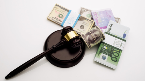 Top view Judge's gavel and packs of dollars and euro banknotes on a white background - Photo, Image