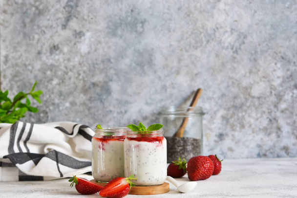Yogurt with chia seeds and strawberries for breakfast.  - Valokuva, kuva