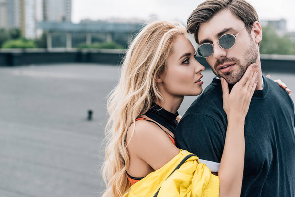 blonde and attractive woman hugging with handsome man in glasses  - Fotografie, Obrázek