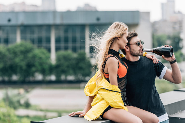 blonde woman in yellow jacket and handsome man drinking champagne  - Foto, imagen