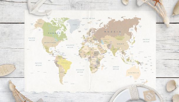 Beyaz ahşap masadaki dünya haritası. Seyahat konsepti. Mermilerle, çapayla, can yelekleriyle ve hatıralarla çevrili bir harita. Üst görünüm. - Fotoğraf, Görsel