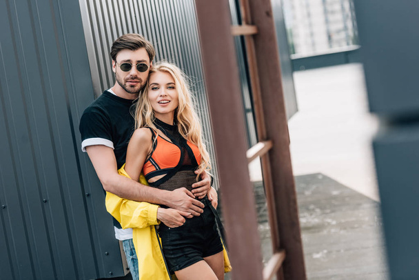 attractive woman and handsome man hugging and looking at camera  - Fotografie, Obrázek
