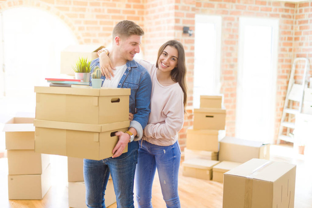 happy man and woman moving to new flat - Photo, Image