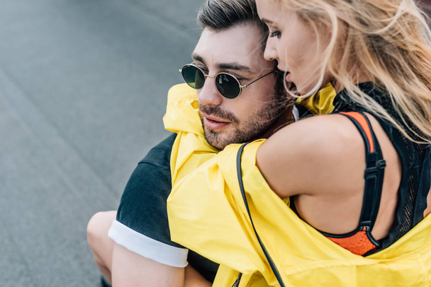beautiful and blonde woman hugging handsome man in glasses  - Photo, Image