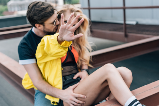 attractive and blonde woman showing hand and handsome man hugging her  - Photo, Image