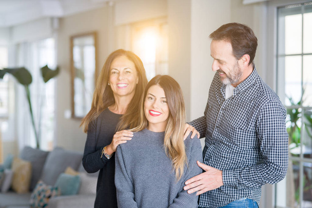 Beautiful family together. Mother, father and daughter smiling and hugging with love at home. - Photo, Image