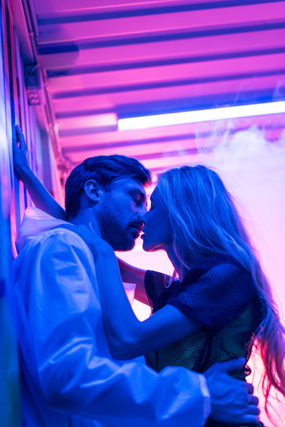 vue latérale de femme attrayante et blonde embrassant et embrassant avec bel homme
  - Photo, image