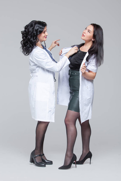 Female doctor examining another woman with stethoscope - Zdjęcie, obraz