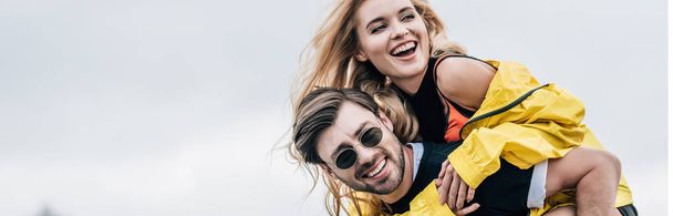 panoramic shot of attractive and blonde woman and handsome man hugging and playing on roof  - Photo, Image
