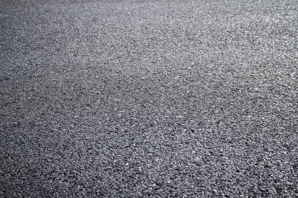 Close-up van donker asfalt weg oppervlak - Foto, afbeelding
