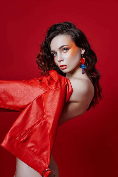 Beautiful makeup of sexy Nude woman in red jacket on red backgro - Фото, зображення