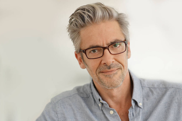 Portrait of handsome mature man wearing glasses smiling at camera - Fotoğraf, Görsel