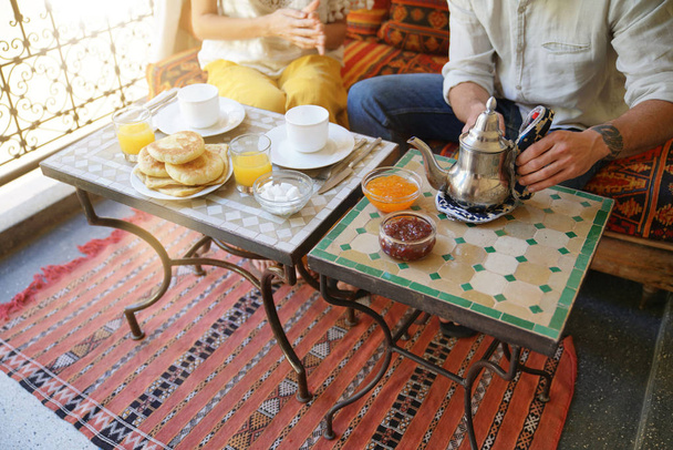 Couple having breakfast in a Riad hotel in Marrakech - Photo, image