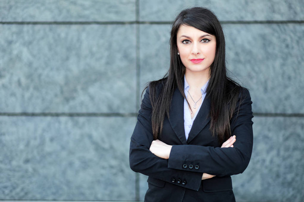 Smiling businesswoman outdoor with crossed arms  - Photo, image
