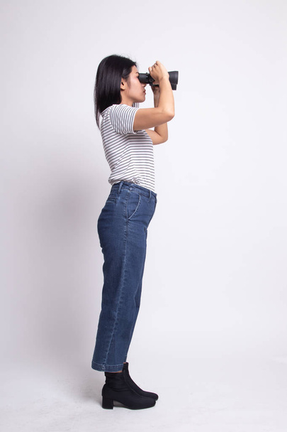 Full body of young Asian woman with binoculars. - Photo, Image
