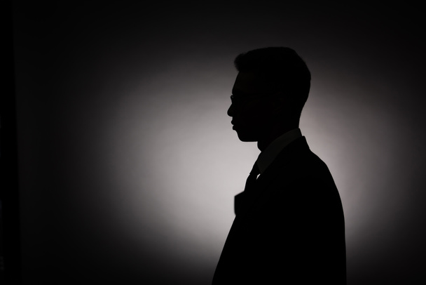 side view of black silhouette of businessman with back light - Fotoğraf, Görsel