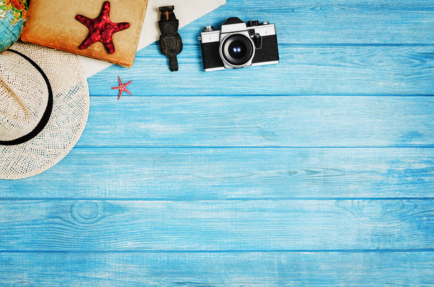 Accessories for travel top view on blue wooden background - Fotoğraf, Görsel