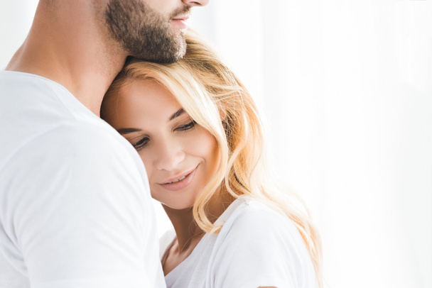 beautiful blonde woman leaning on bearded man with copy space - 写真・画像