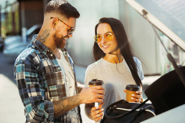 Young couple preparing for vacation trip on the car in sunny day - Photo, image