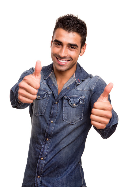 Portrait of a young man showing thumbs up - Foto, afbeelding