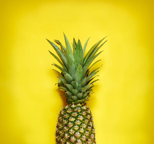 Fresh pineapple on yellow background - Valokuva, kuva