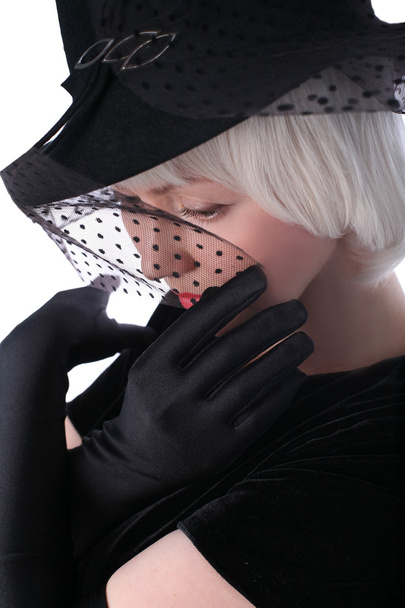 Lovely woman in hat hiding at veil - Fotó, kép