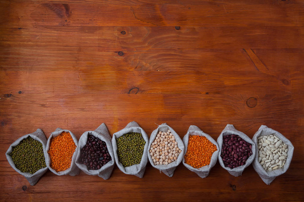 beans, lentils, peas, soybeans in bags horizontally with a copy  - Photo, Image