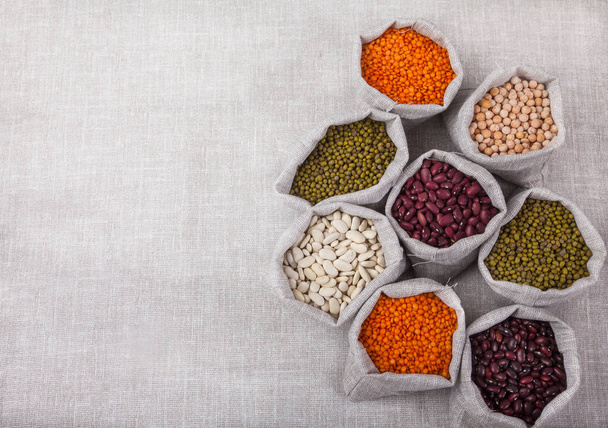 red and white beans, red lentils, soybeans, peas in bags . keto  - Fotoğraf, Görsel