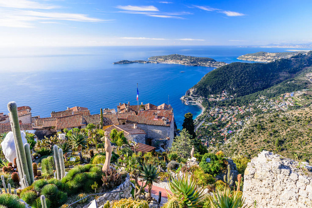 Eze town, France - March 9, 2018: Scenic view of the Mediterranean coastline and medieval houses from the top of the town of Eze village on the French Riviera - Foto, afbeelding