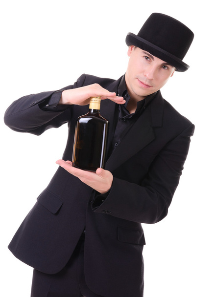 Retro stylish man in black suit with bottle of drink - Photo, image