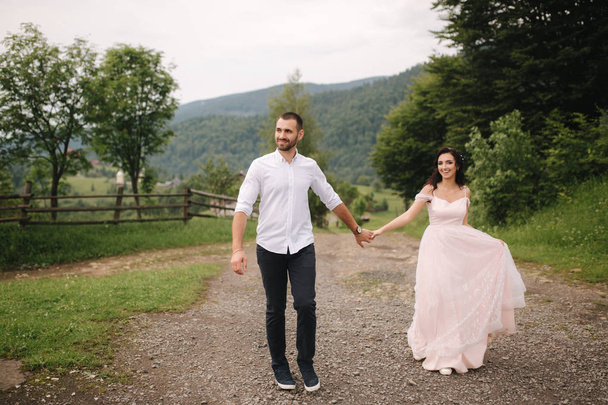 Beautiful wedding couple in Carpathian mountains. Handsome man with attractive woman - Φωτογραφία, εικόνα