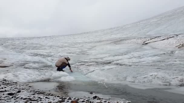 Crystal poreallas käynnissä lumiset vuoret ja turisti ottaa vettä Slo-mo
 - Materiaali, video