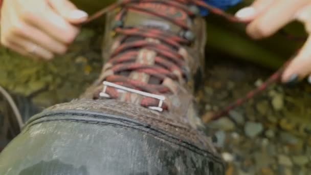 Big mountain boot with multicolored laces standing on mountain soil - Footage, Video