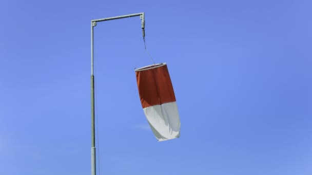 A windsock swaying in the wind against blue sky on a sunny day. - Footage, Video