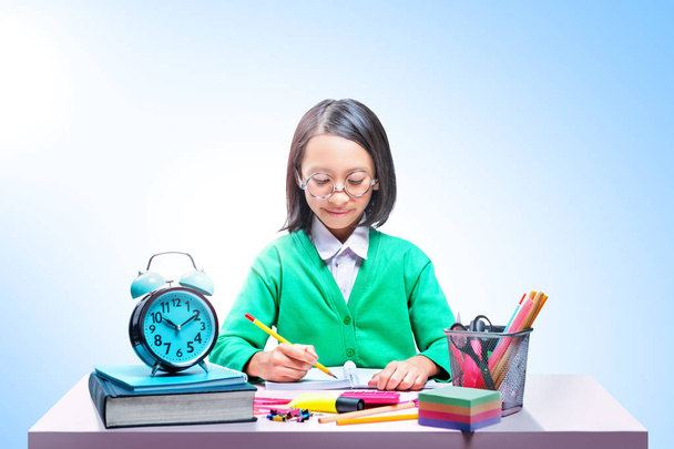 Asian cute girl in glasses learning with school stationary on th - Foto, immagini