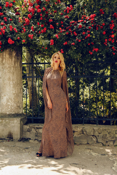  sensual woman with blond hair in elegant dress posing near rose - Фото, зображення