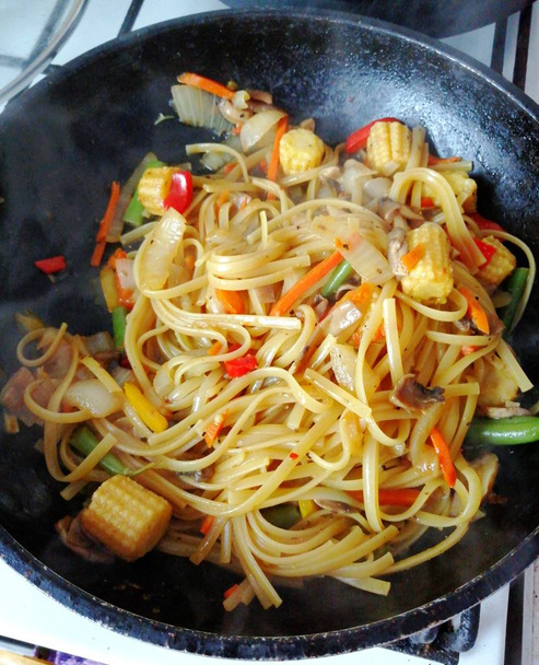 Wok noodles with vegetables, hot pasta in a frying pan with vegetables. - Photo, Image