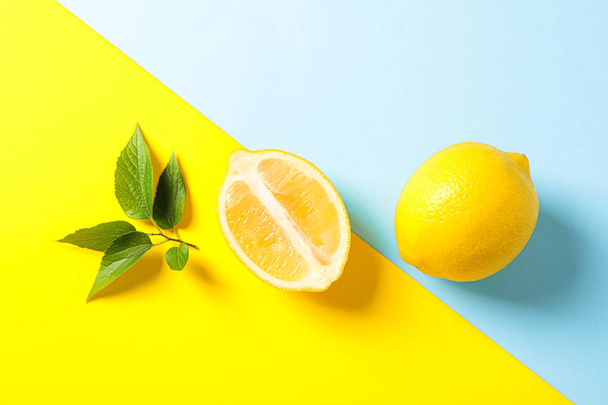 Flat lay composition with lemons on two tone background, space f - Photo, Image