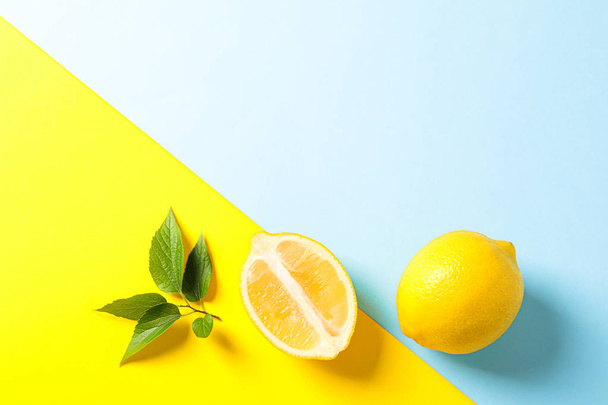 Flat lay composition with lemons on two tone background, space f - Photo, Image