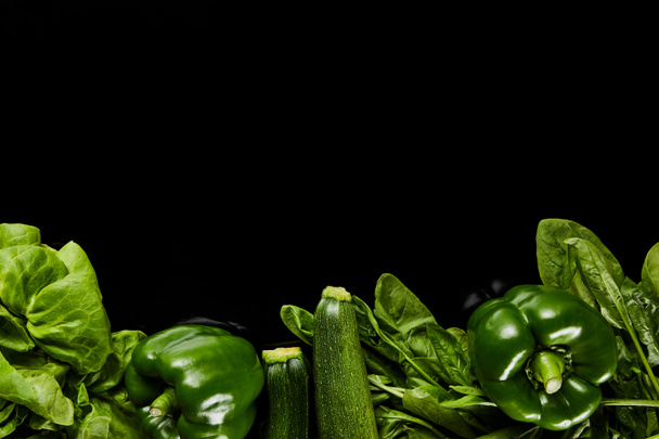 top view of fresh organic green vegetables isolated on black - Photo, Image