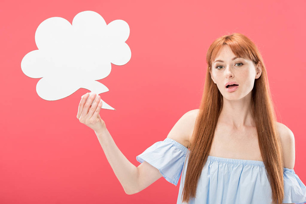 surprised redhead young woman holding empty thought bubble isolated on pink - Photo, image