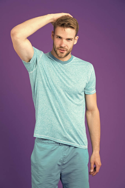 Masculinity concept. Man with muscular arms confident and strong. Does having muscular body make you more confident. Strong and muscular. Man strict handsome unshaven guy on violet background - Foto, Bild