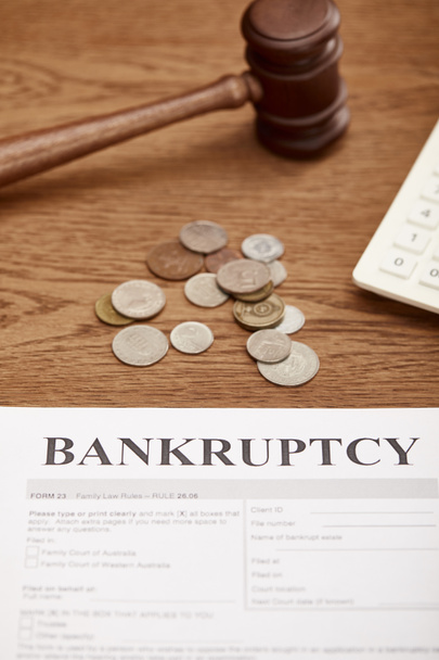 bankruptcy form, gavel and coins on brown wooden table - Фото, зображення