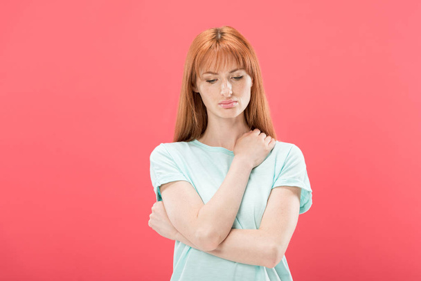 front view of pensive redhead young woman looking down isolated on pink - Foto, Imagem